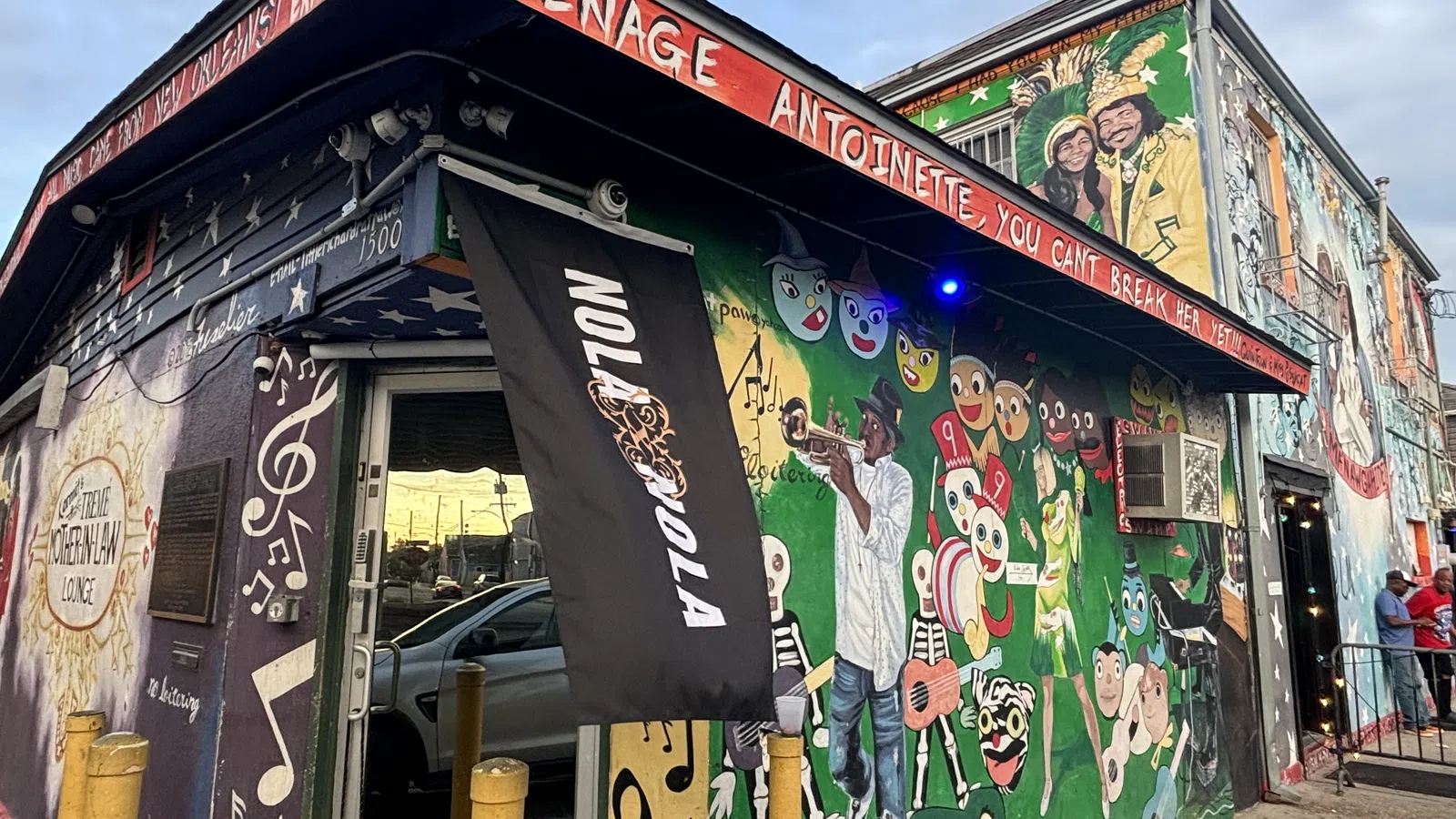 Colorful exterior of Teenage Antoinette adorned with murals and lively art, capturing the essence of community and creativity.