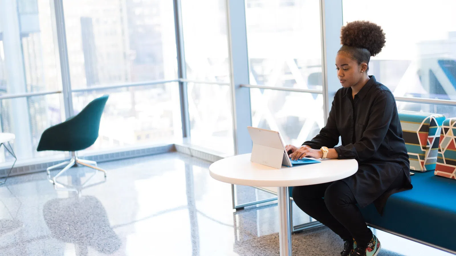 a man sitting at a table with a laptop