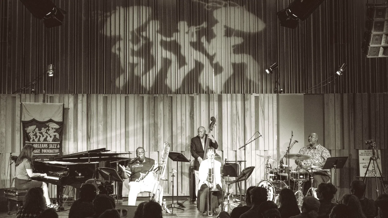a group of people playing instruments on a stage
