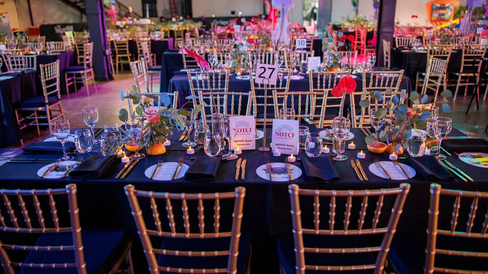 a table with chairs and tables with flowers on it