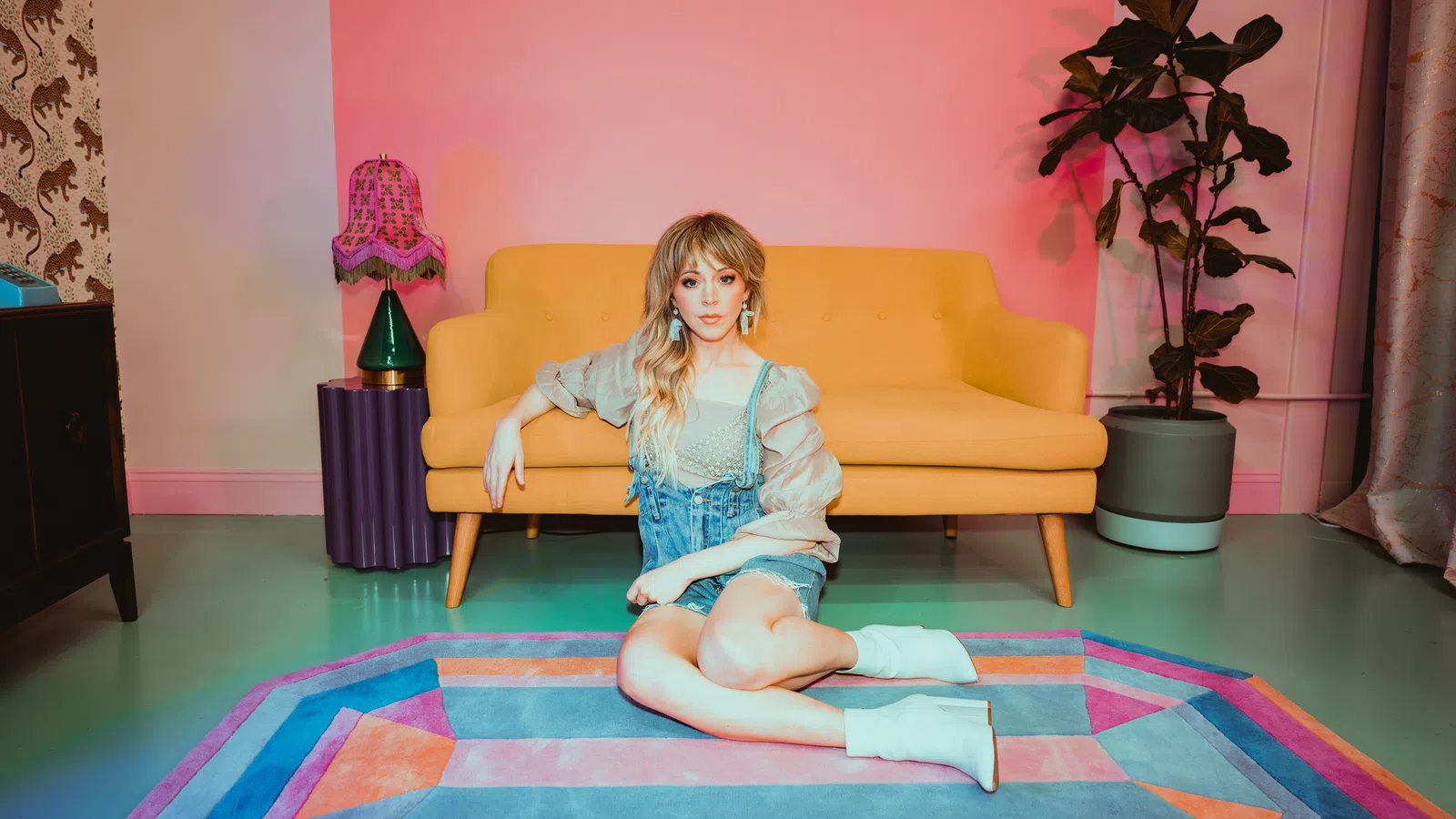 a girl sitting on a rug
