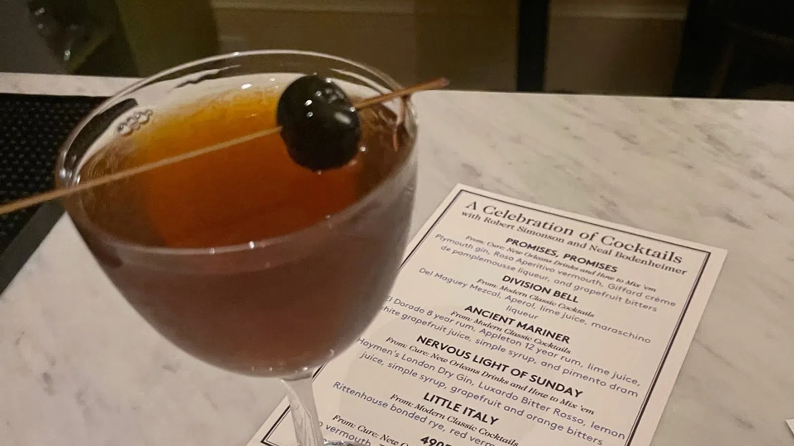 a glass of liquid with a spoon