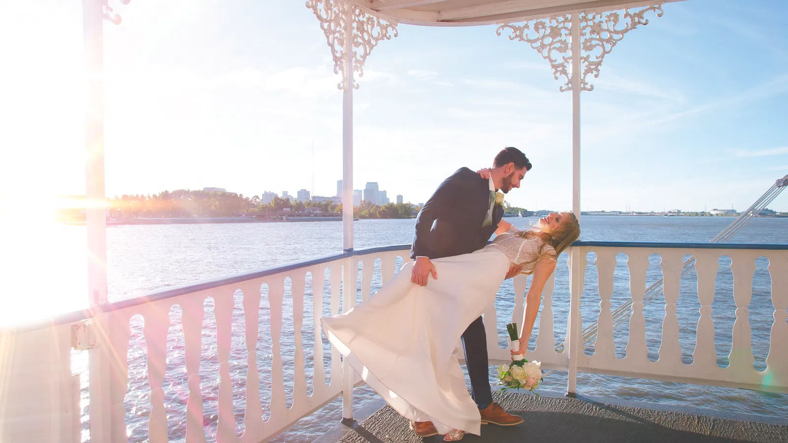 a man and woman kissing on a balcony