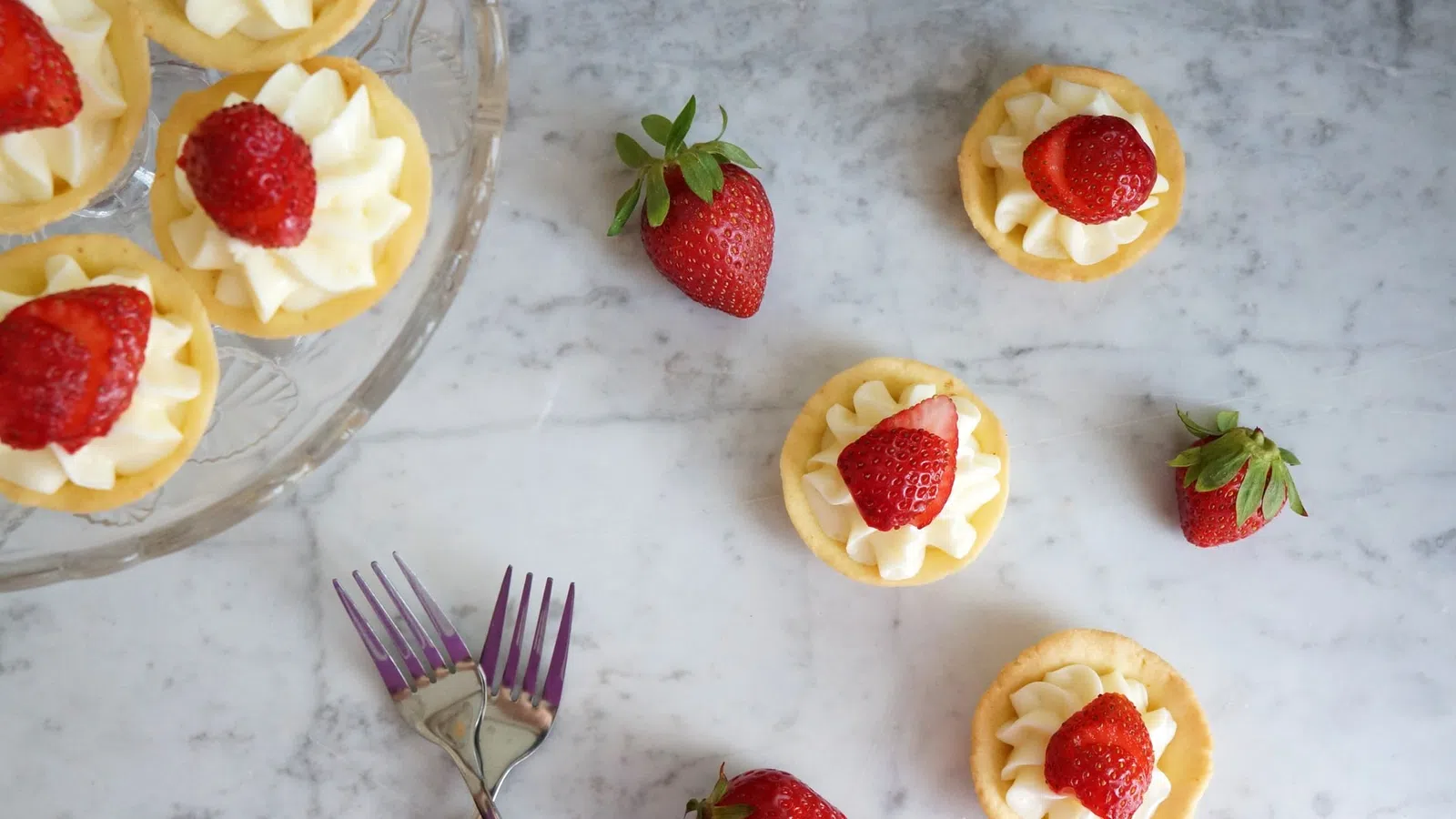 a group of desserts with strawberries and a fork