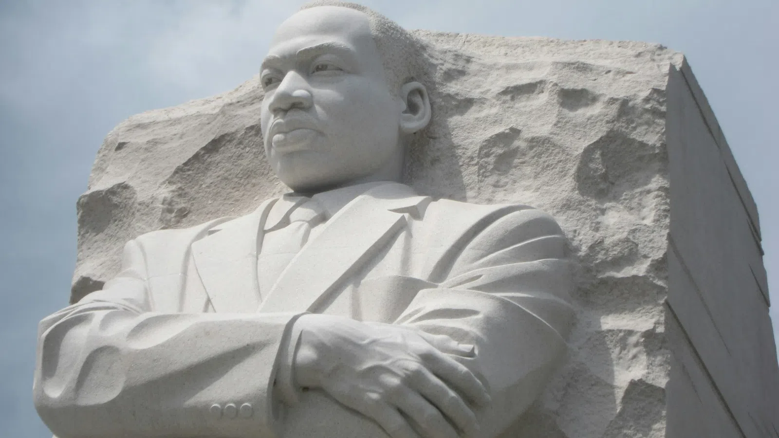 a statue of a man with Martin Luther King Jr. Memorial in the background
