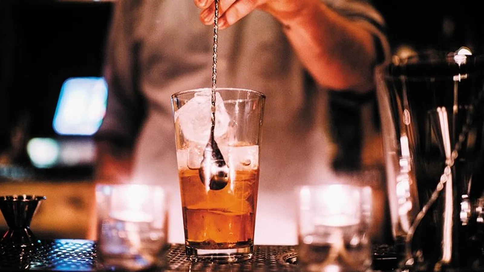 a person pouring liquid into a glass