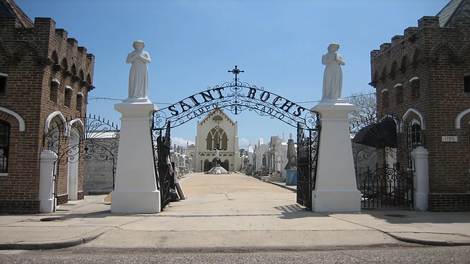 a statue in front of a gate