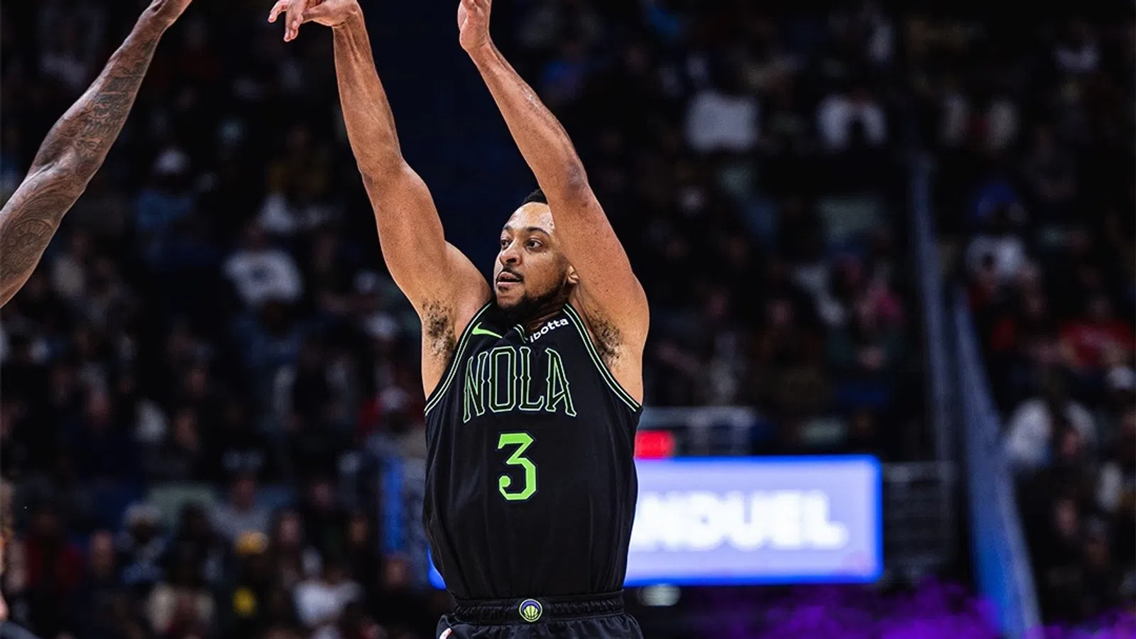 C.J. McCollum holding the arms up