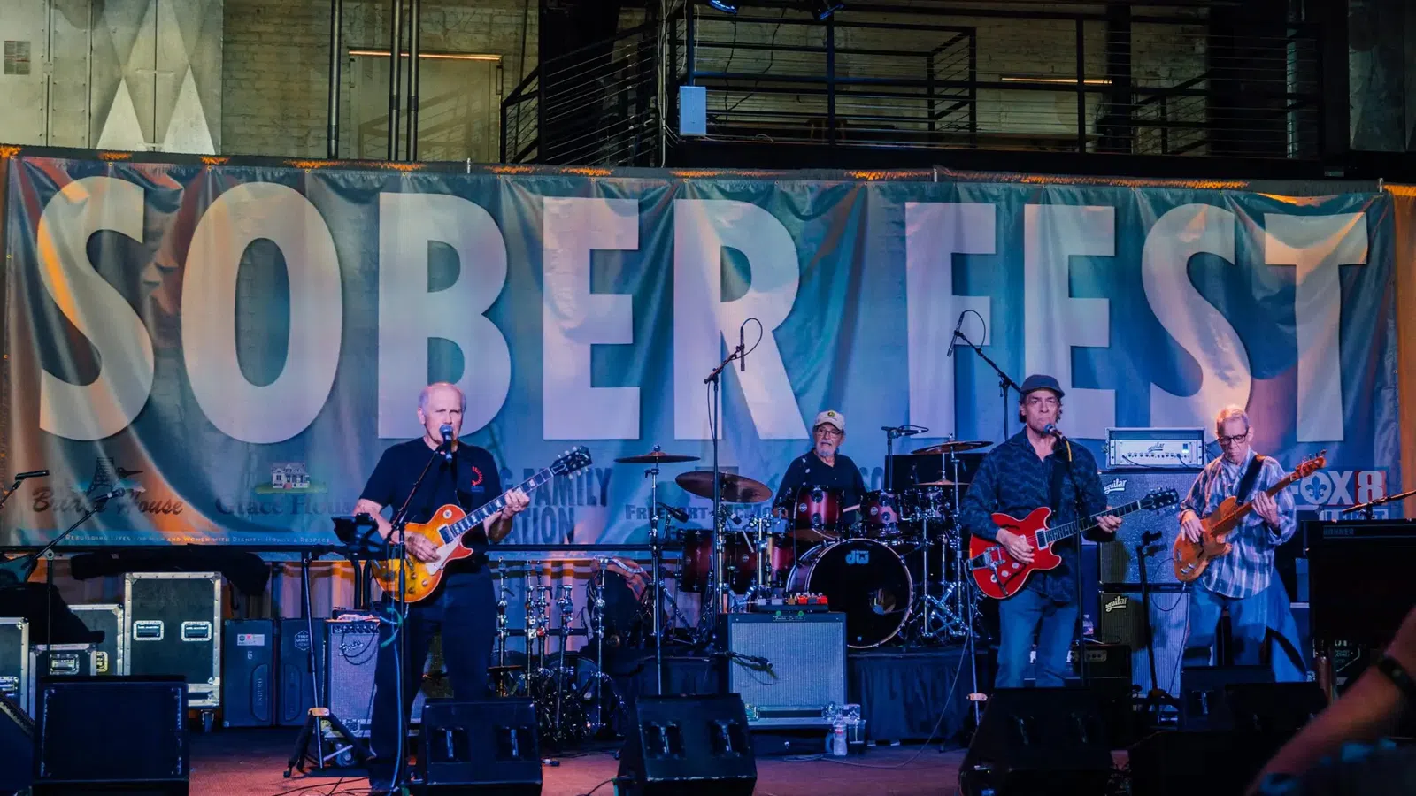 a group of people playing instruments on a stage