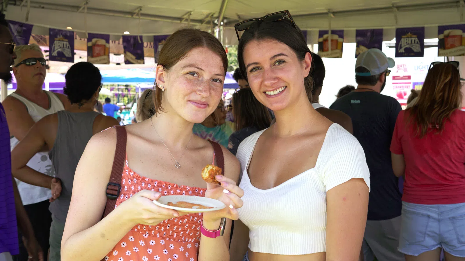 two women holding food