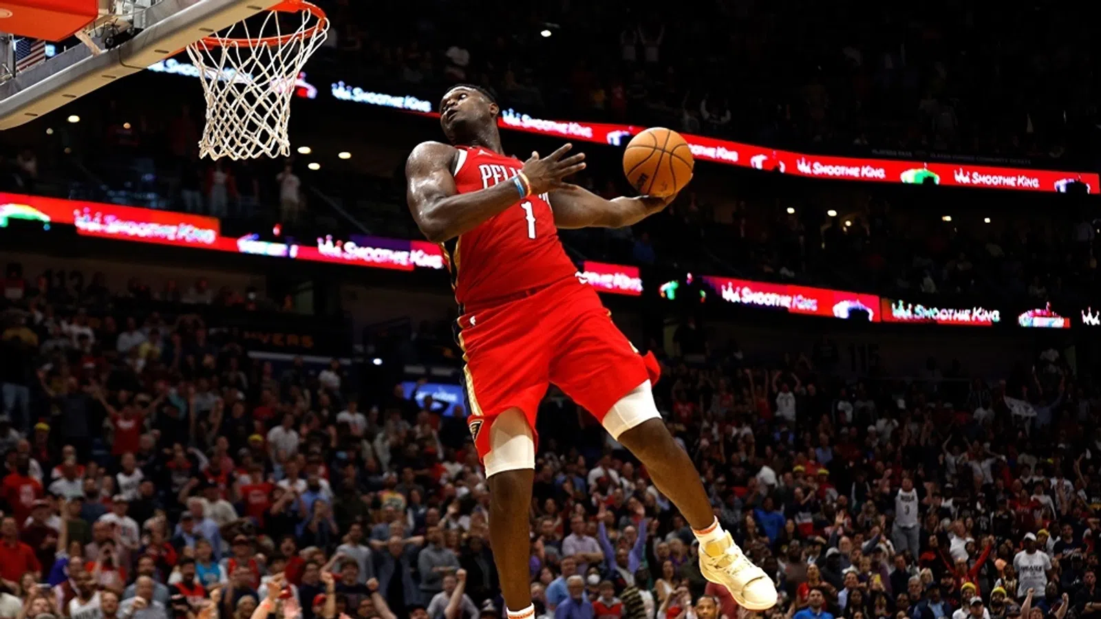a basketball player jumping to dunk a basketball