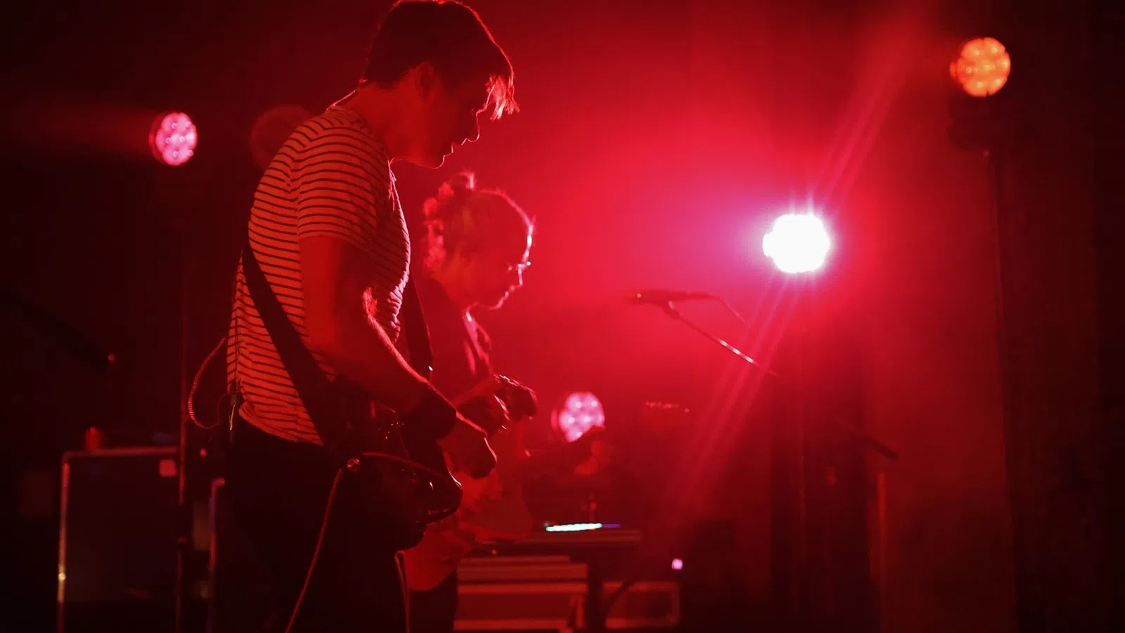 a man playing a guitar on a stage