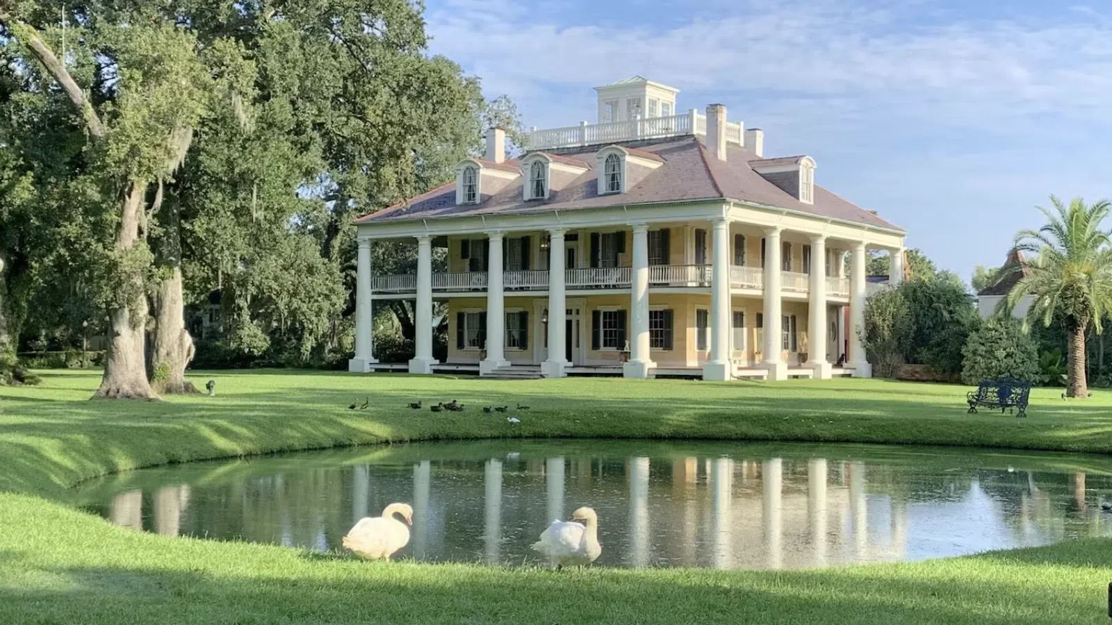 a large building with a pond in front of it