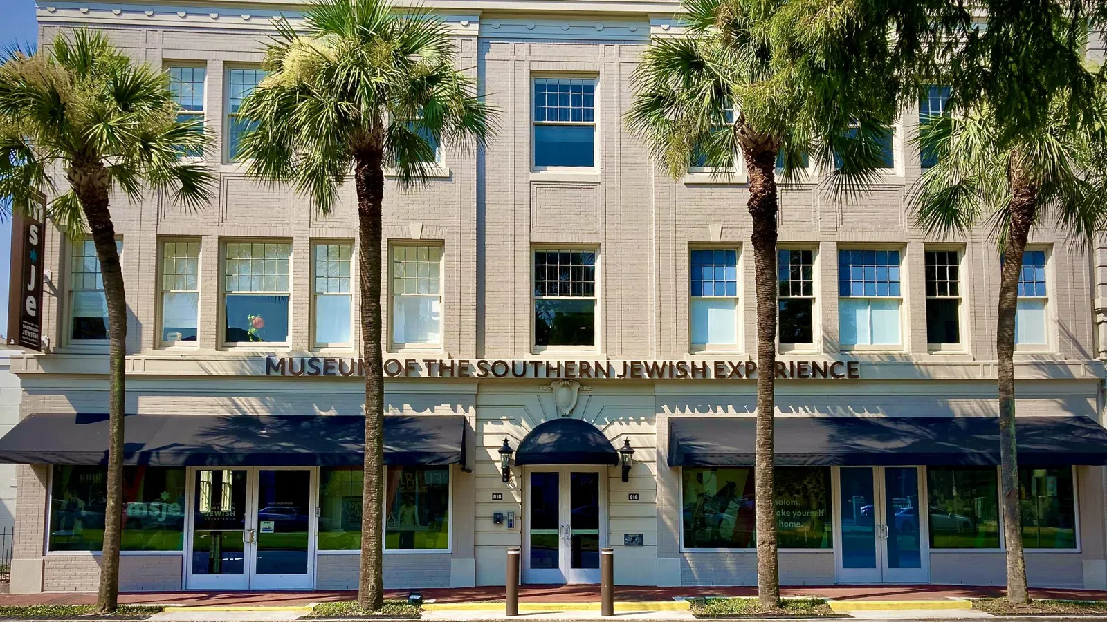 a building with palm trees in front