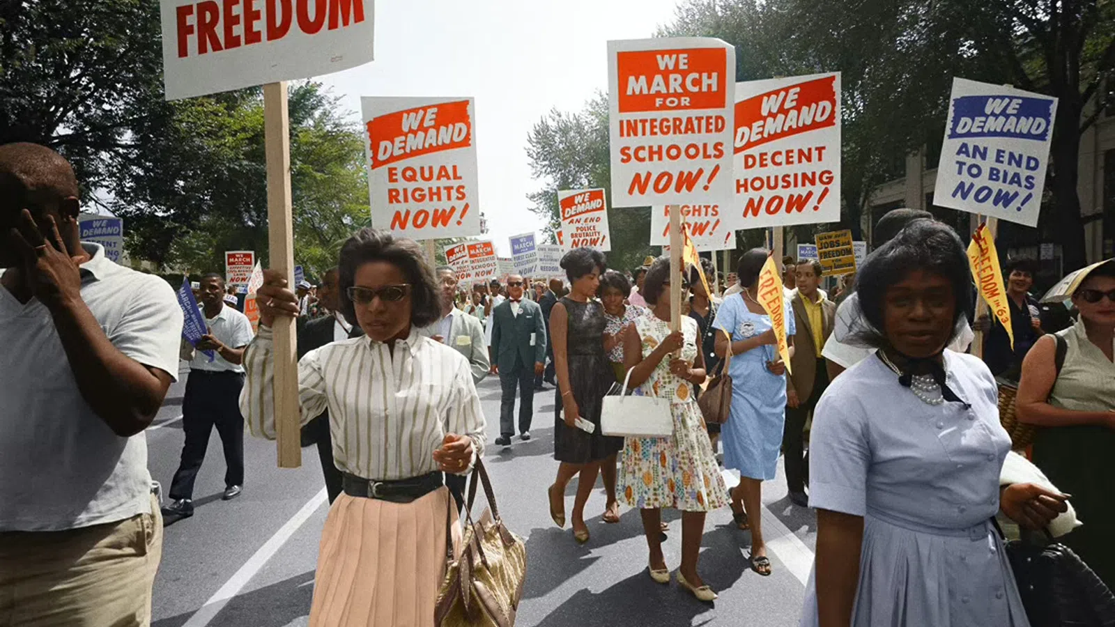 a group of people marching in the street