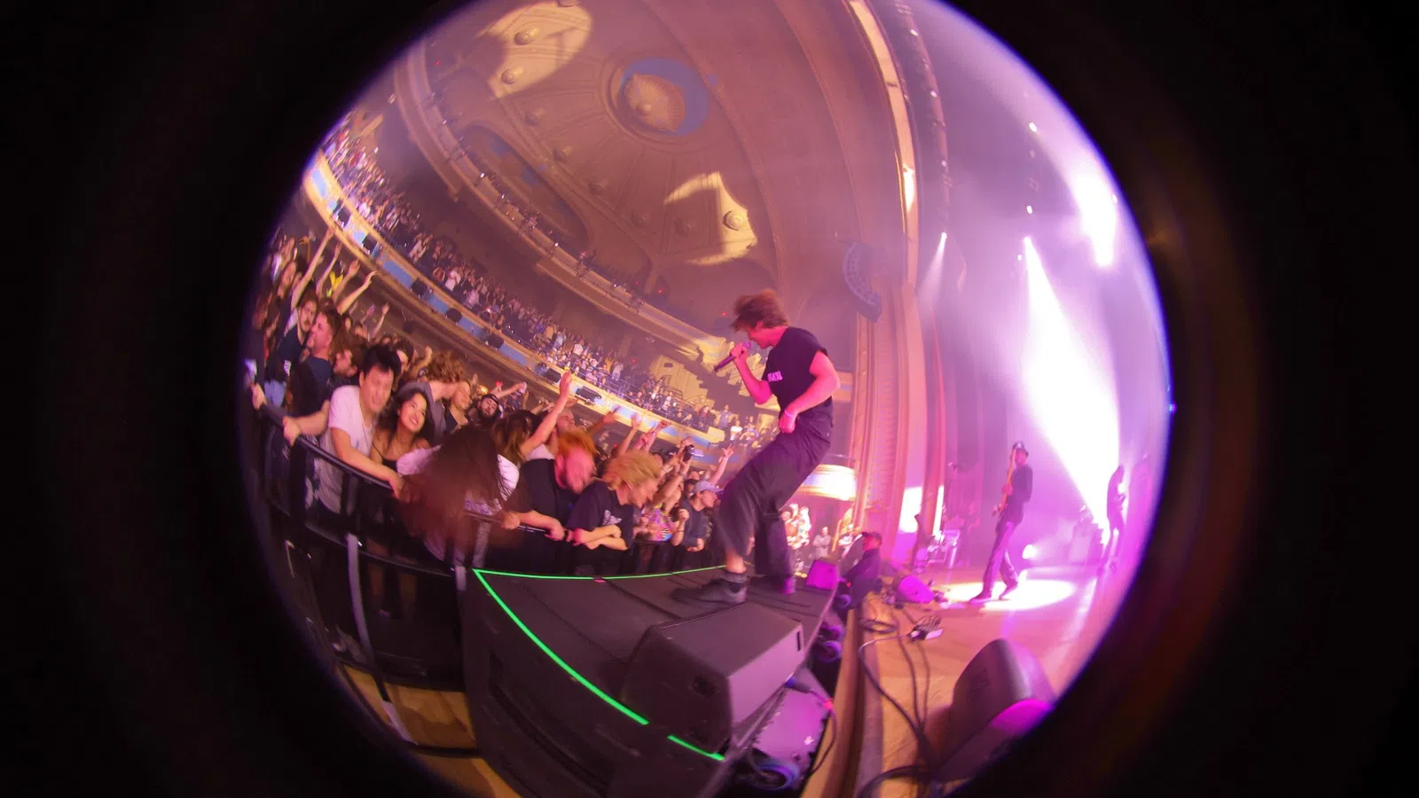 a person on a stage with a crowd watching