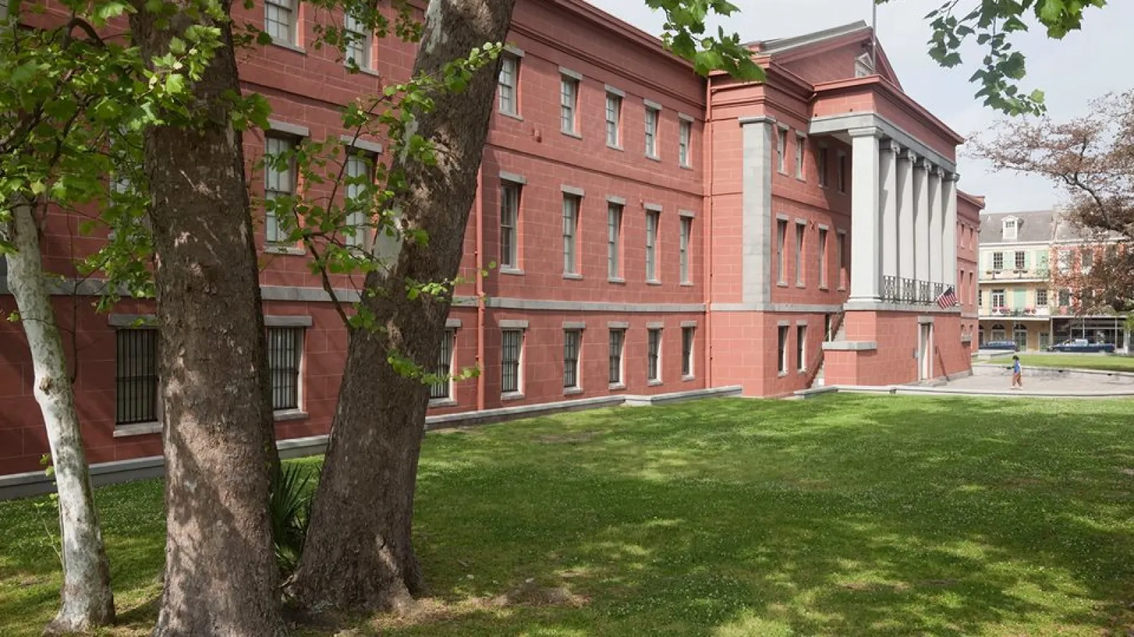 a large red building with trees in front of it