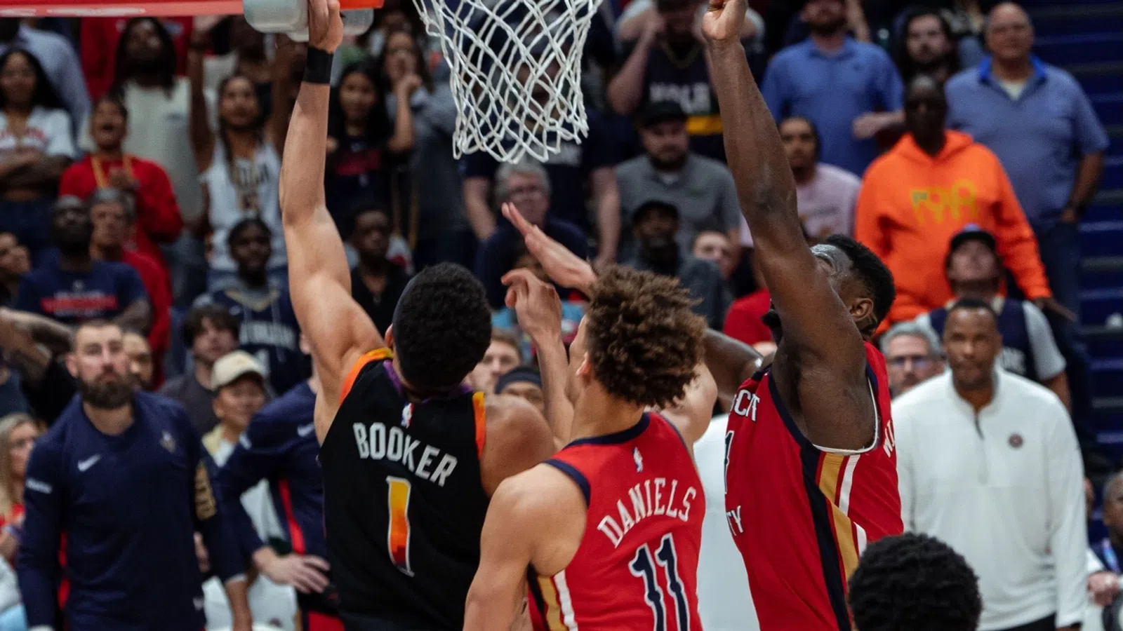 a group of men playing basketball