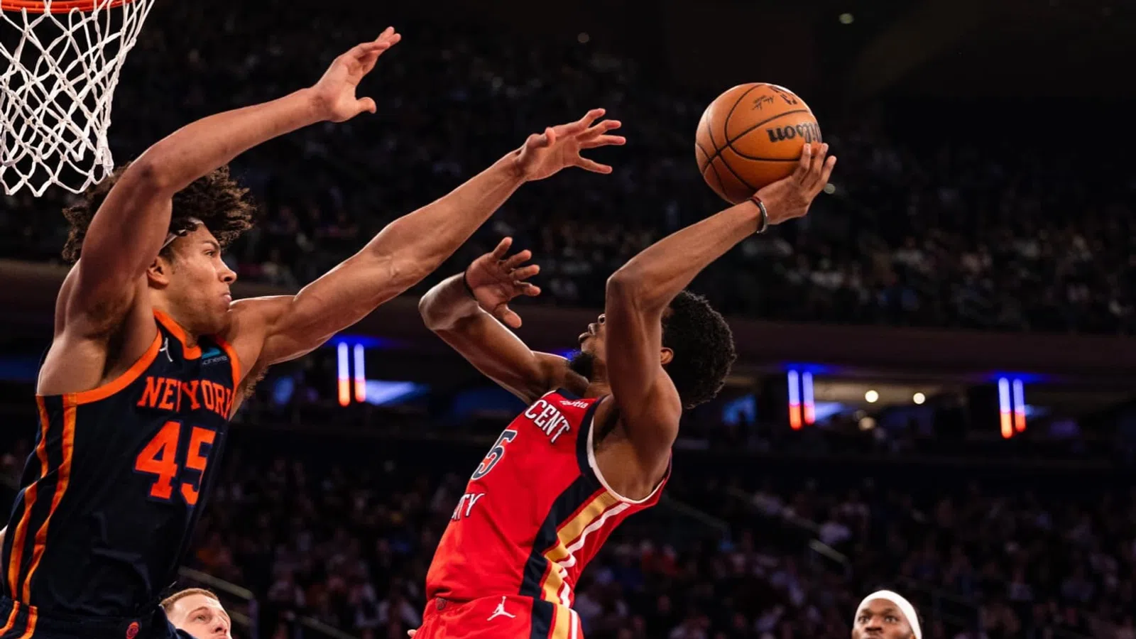 a basketball player jumping to make a shot