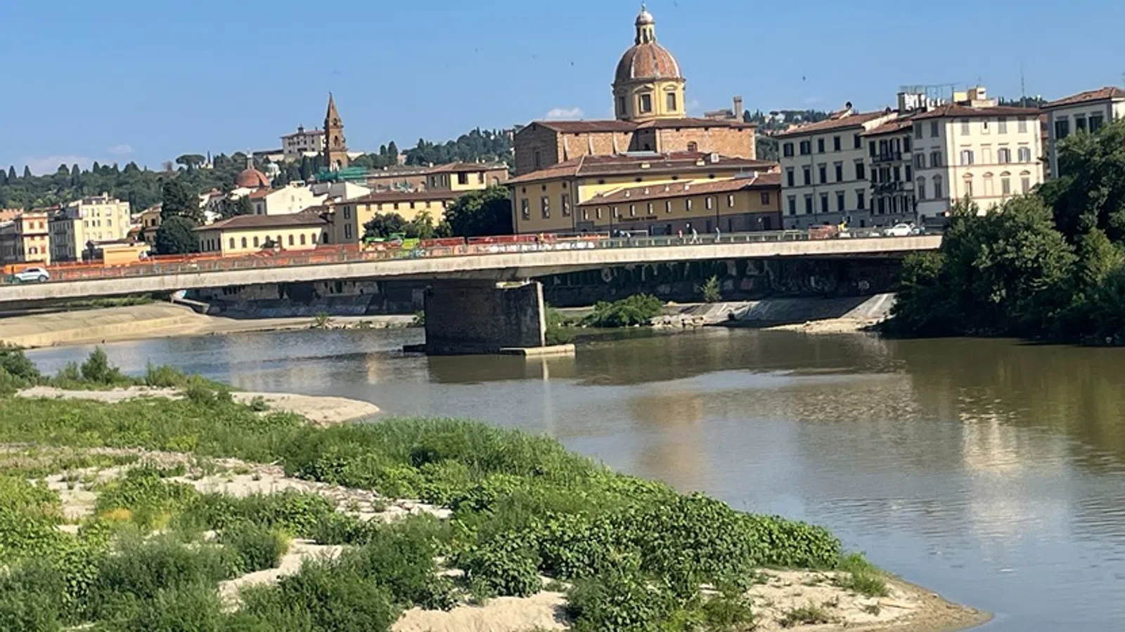 a bridge over a river with buildings in the background