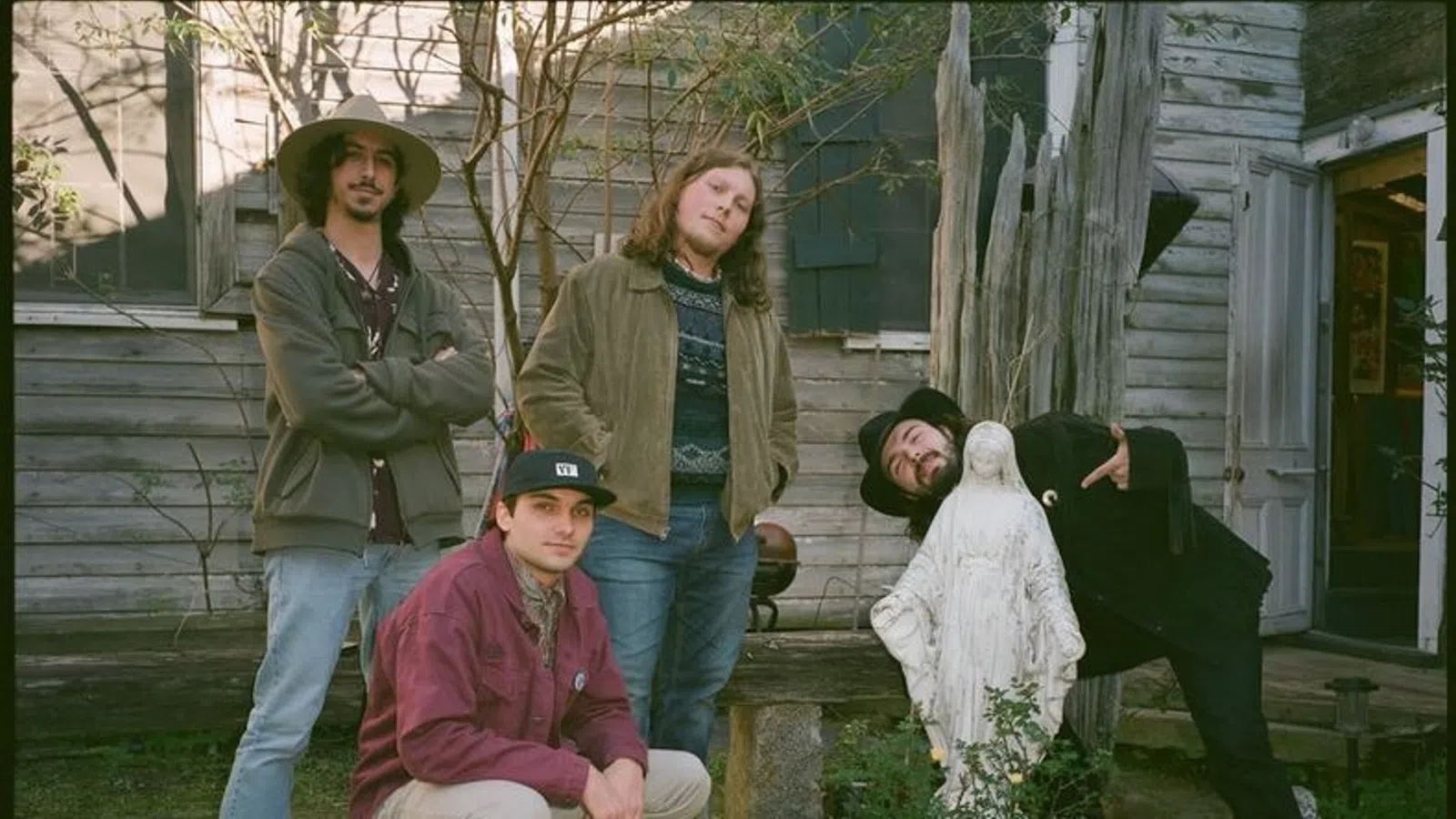 a group of people posing for a photo with a bird