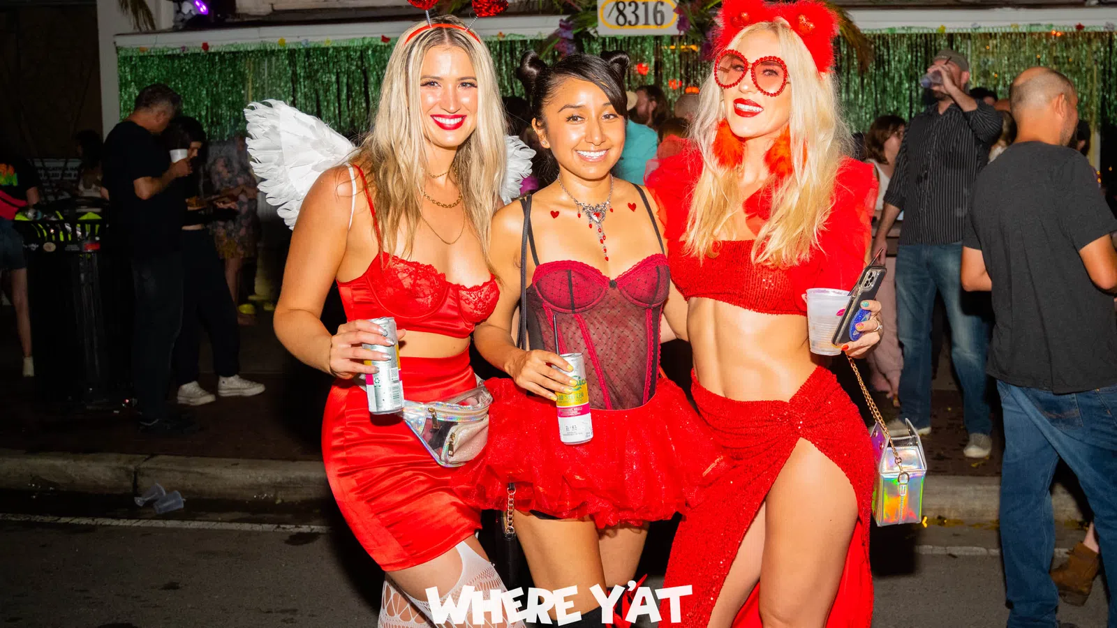 a group of women in red dresses