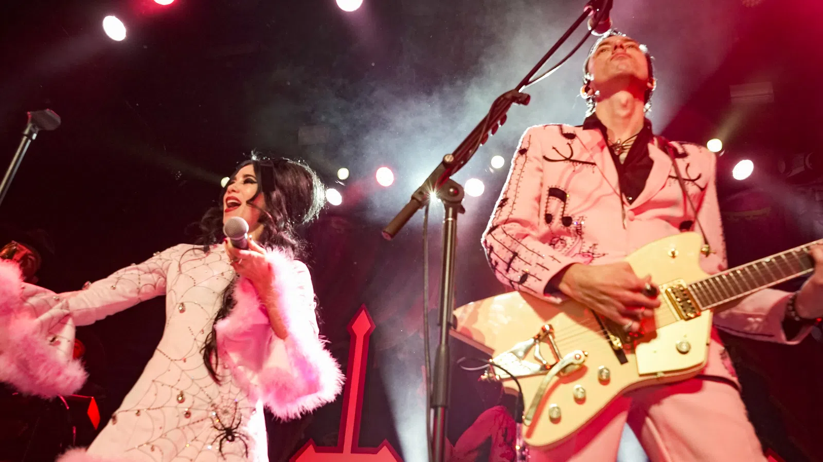 a man and woman playing guitar