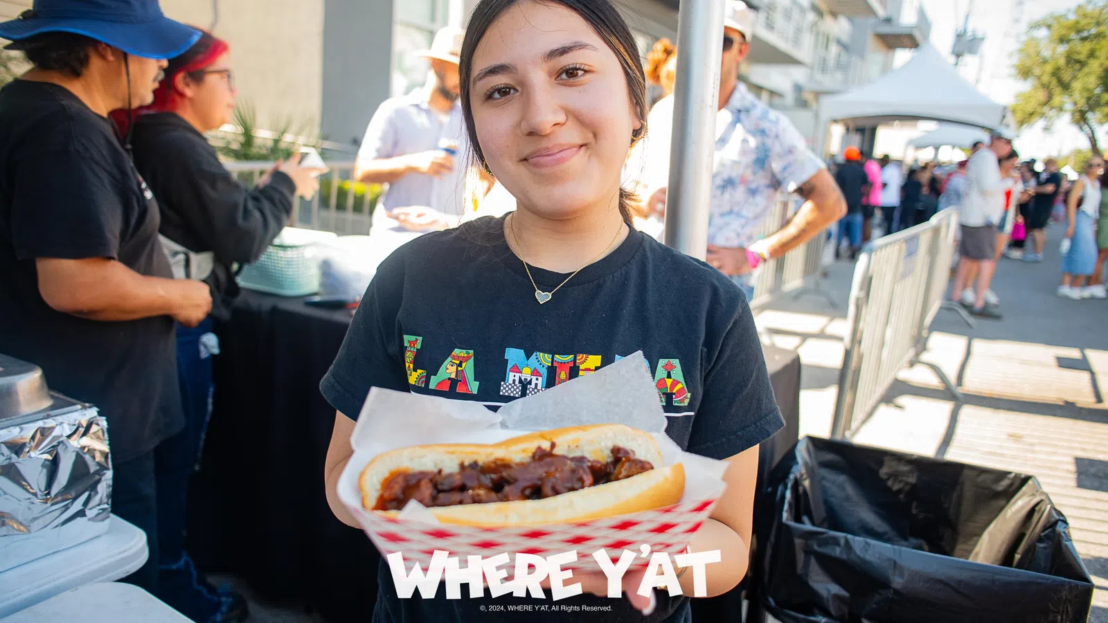 a woman holding a hot dog