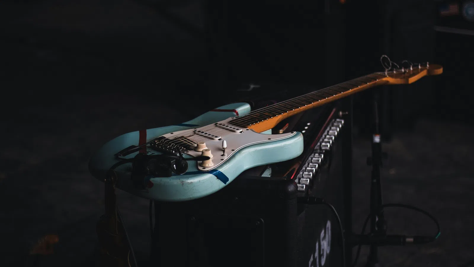 a couple of guitars on a stand