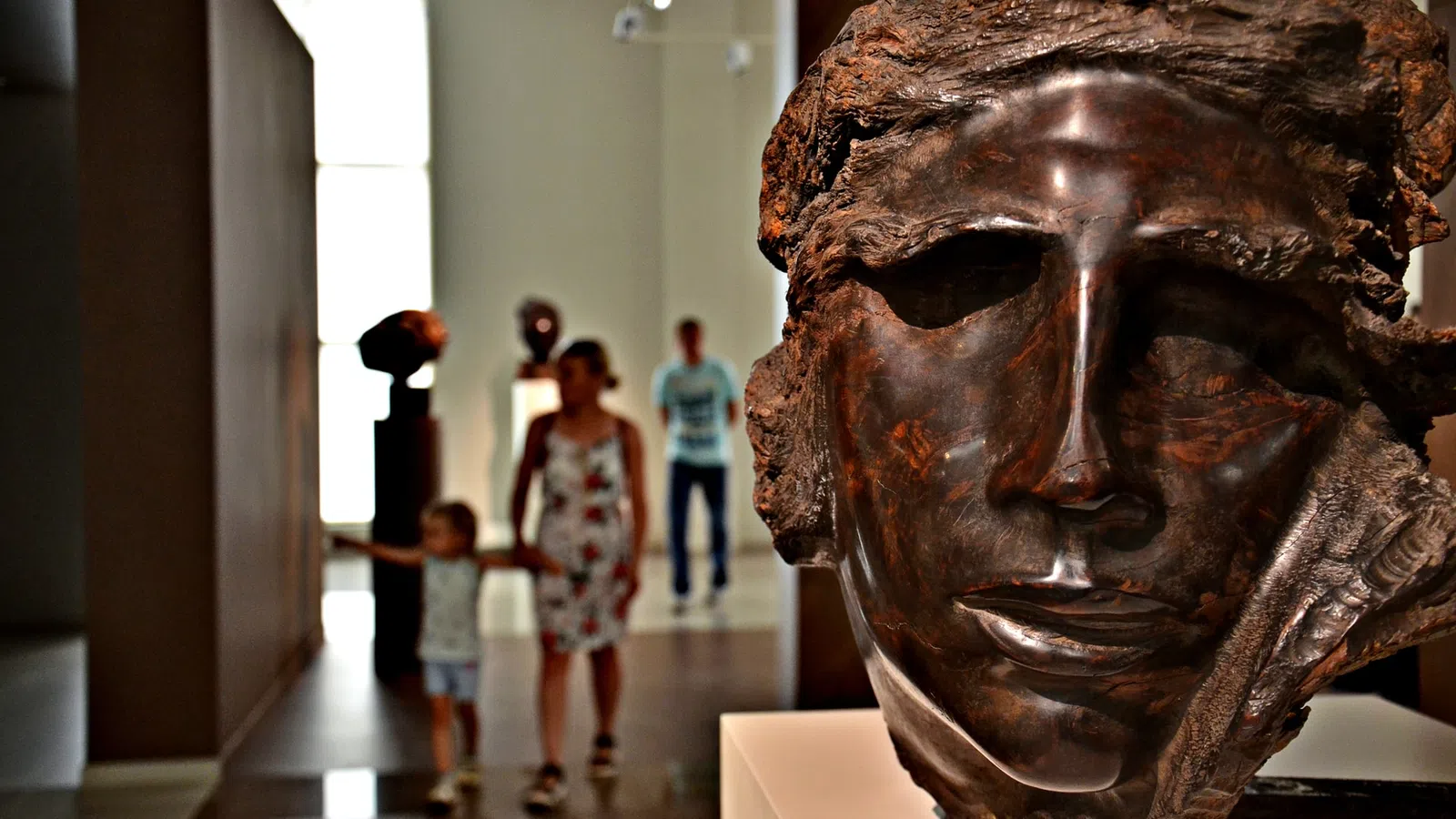 a group of people walking through a museum