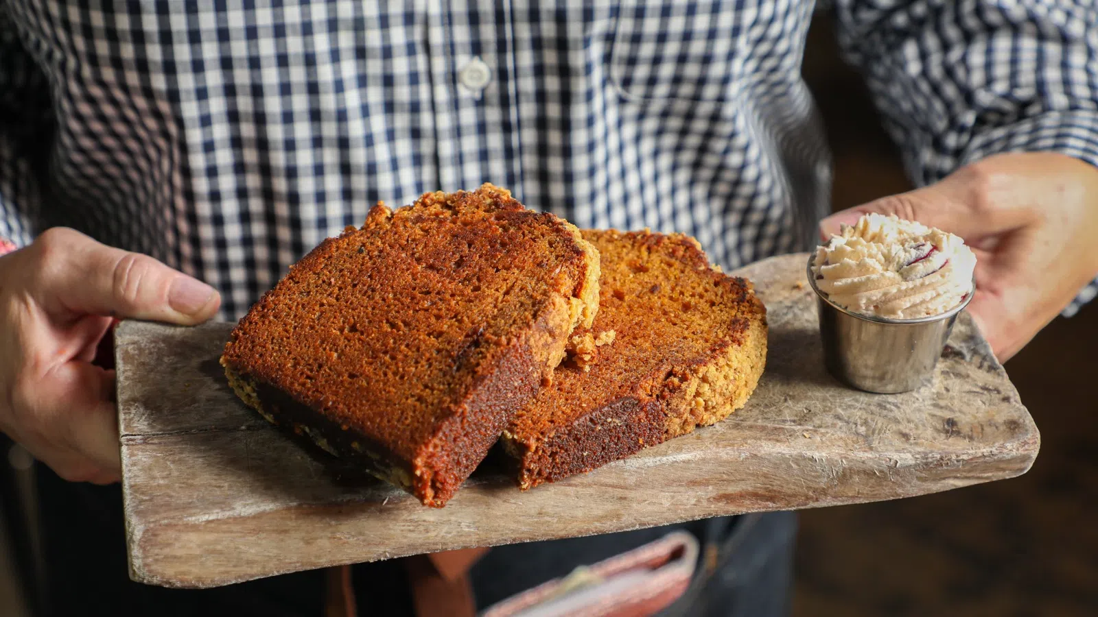 a person holding a loaf of bread