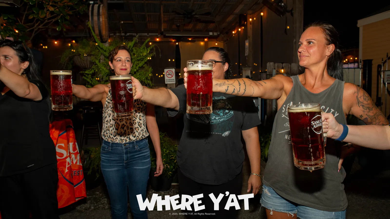 a group of people holding glasses of beer