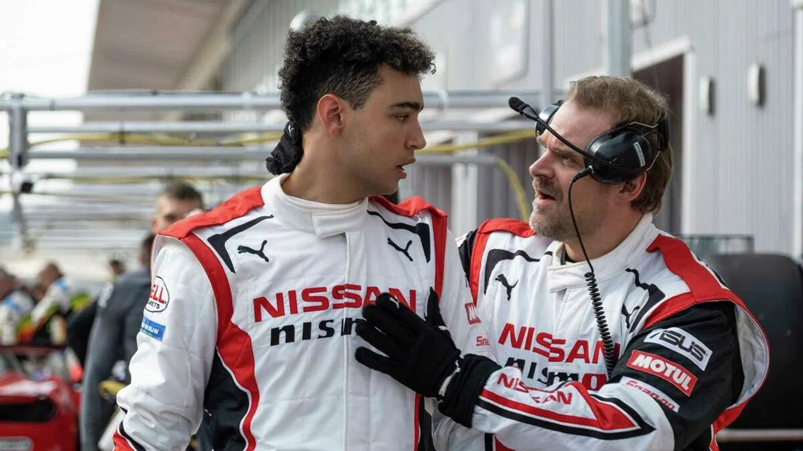 two men wearing racing uniforms