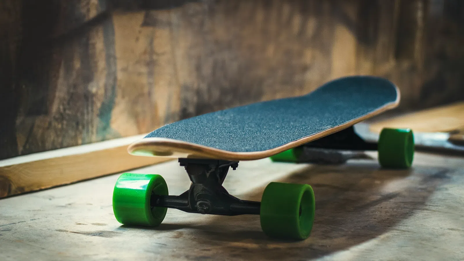 a couple of skateboards on a wood surface