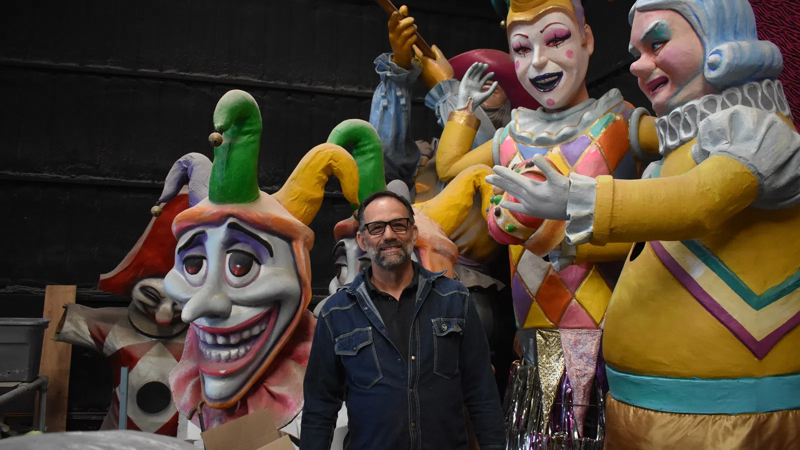 a person standing next to a group of people in clothing