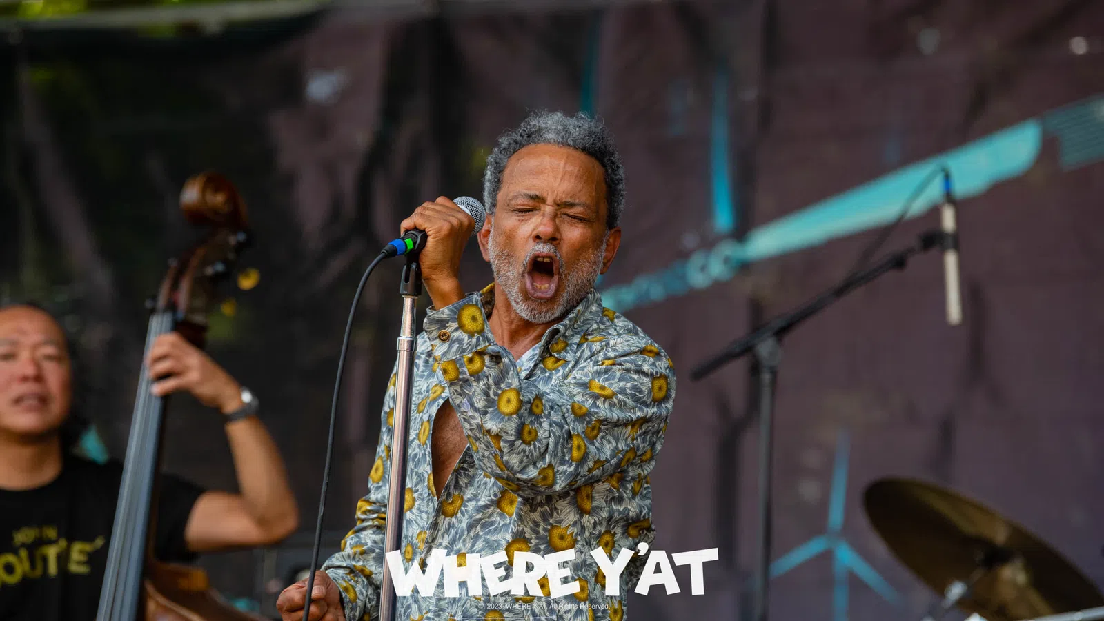 John Boutté singing into a microphone