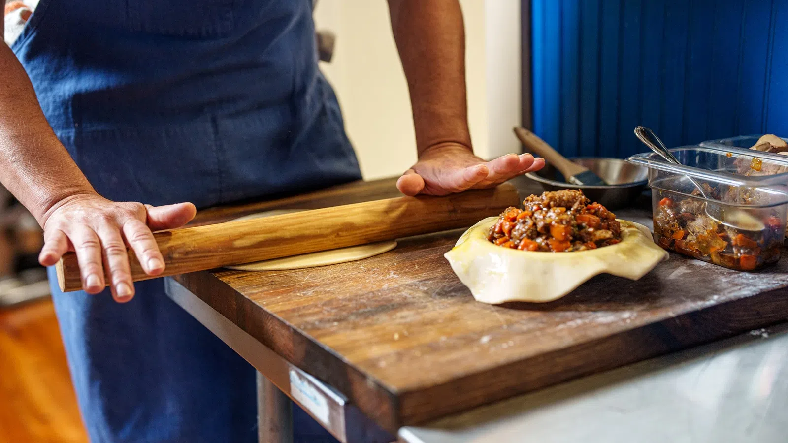 a person cutting a pizza