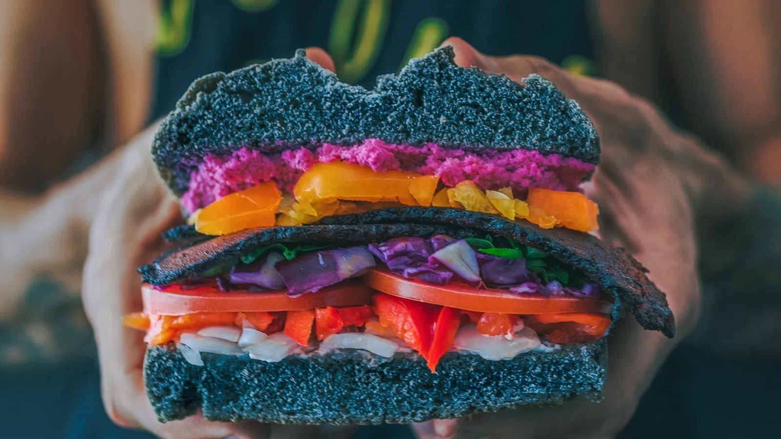 a person holding a burger