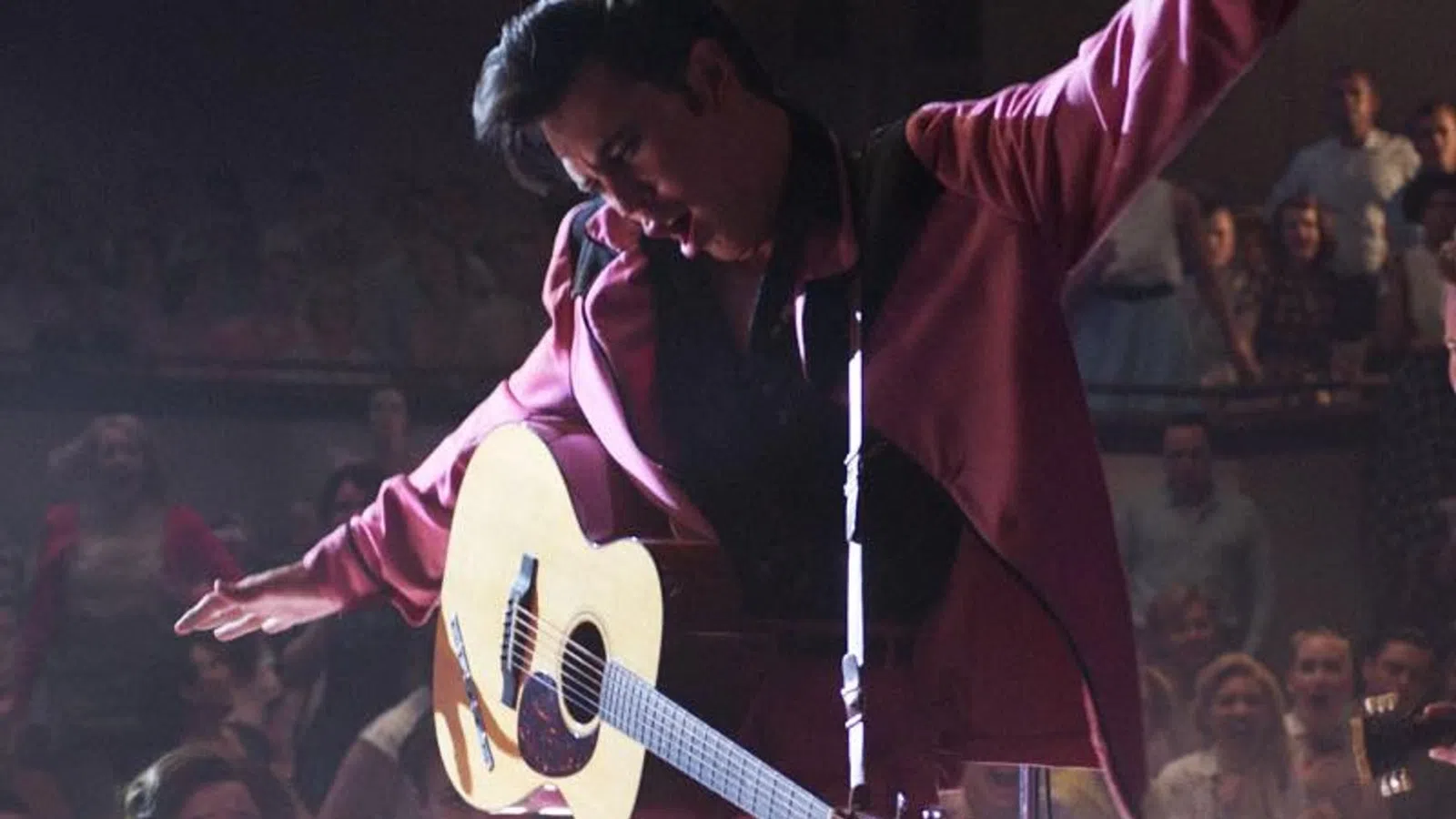 a person playing a guitar on a stage