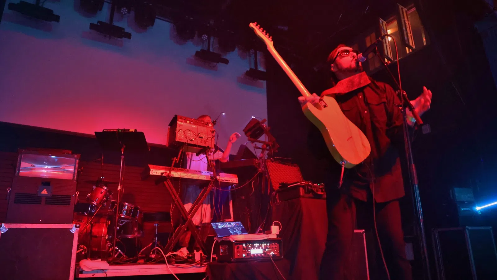 a man playing a guitar on a stage