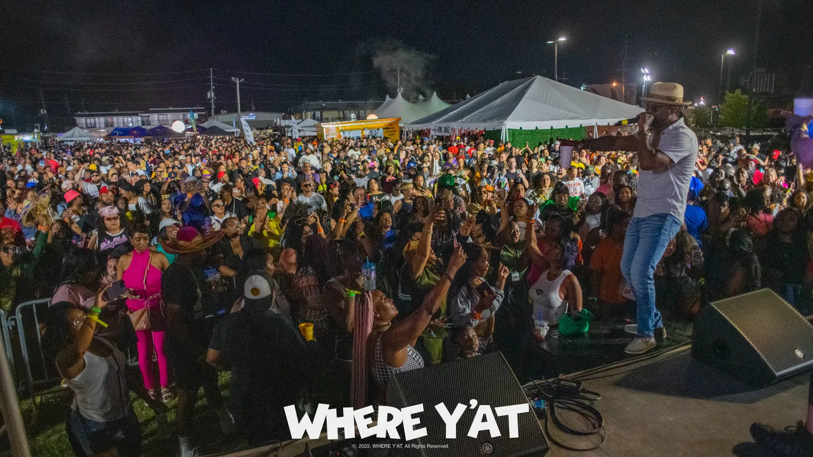 a person on a stage with a crowd watching