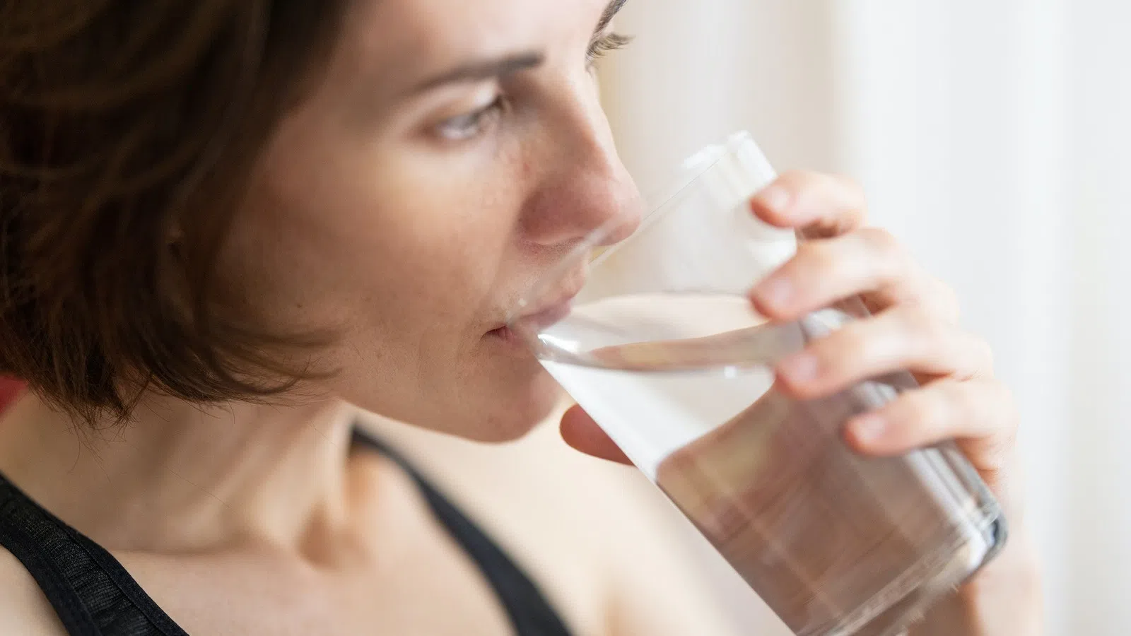 a woman drinking from a glass