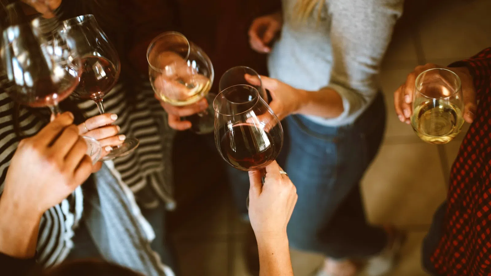a group of people holding wine glasses