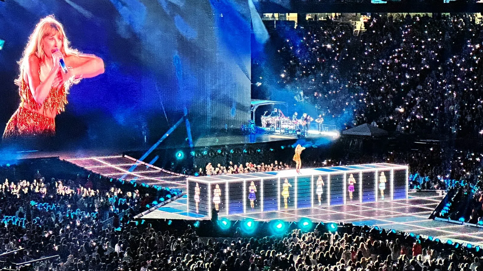 a person on stage with a crowd watching