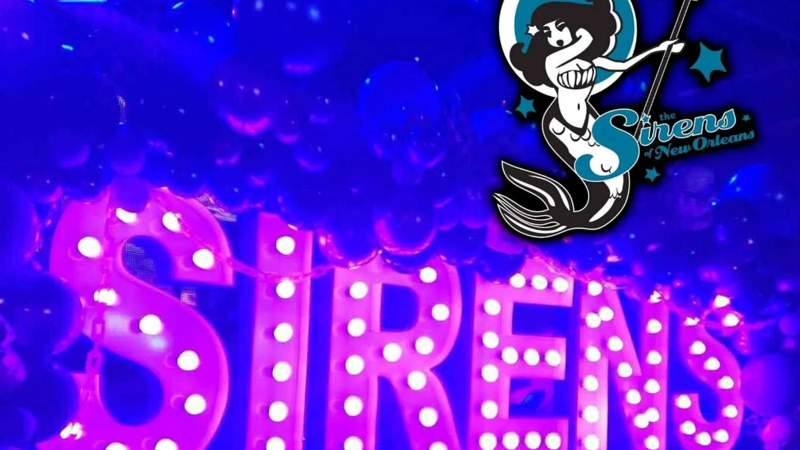 Illuminated marquee letters spelling SIRENS surrounded by balloons with The Sirens logo in neon blue and purple lighting.