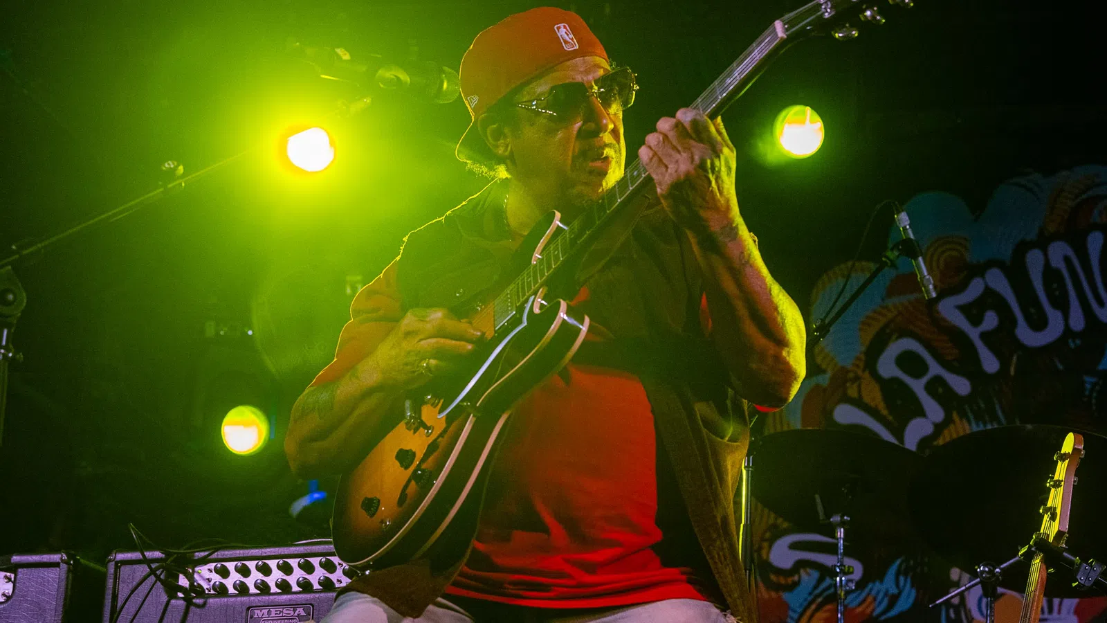 a person playing a guitar on a stage