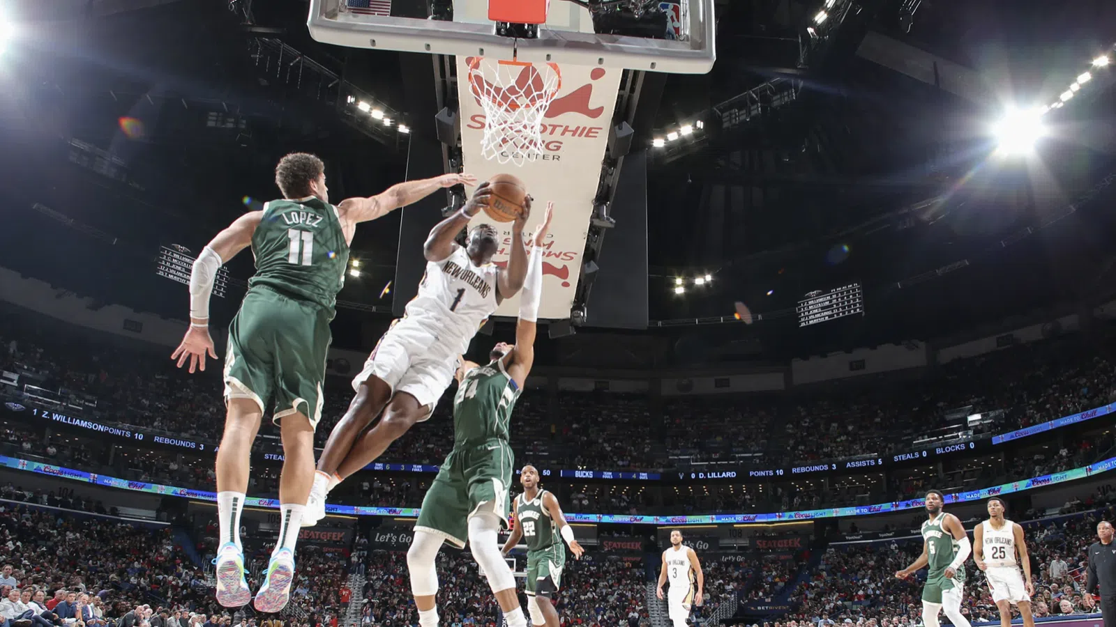 a basketball player jumping to dunk a basketball