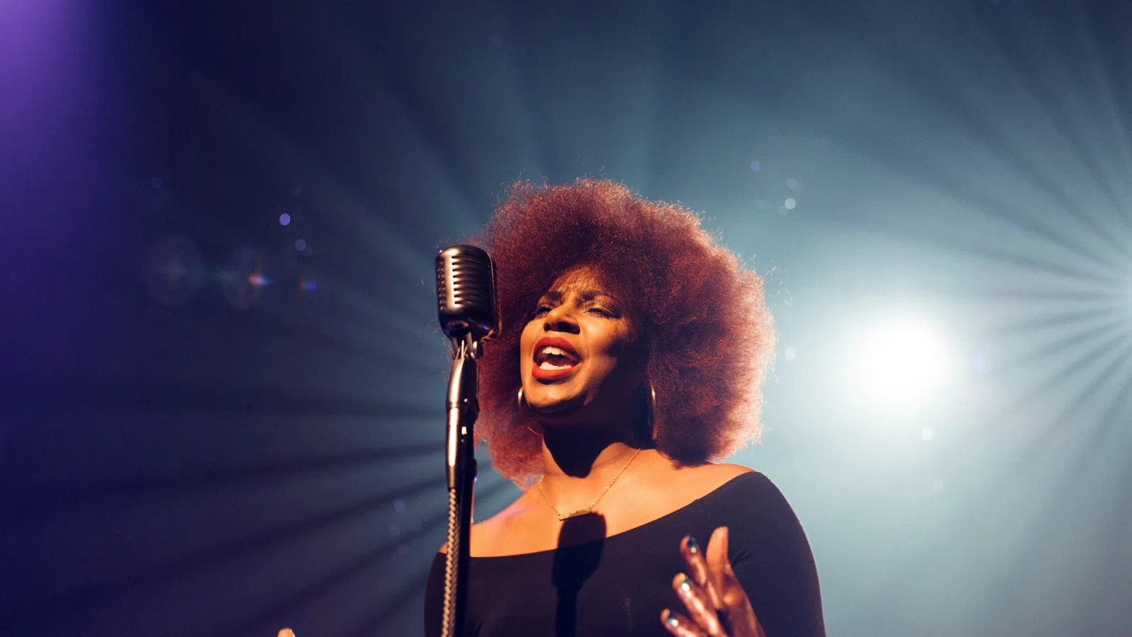 a person singing into a microphone