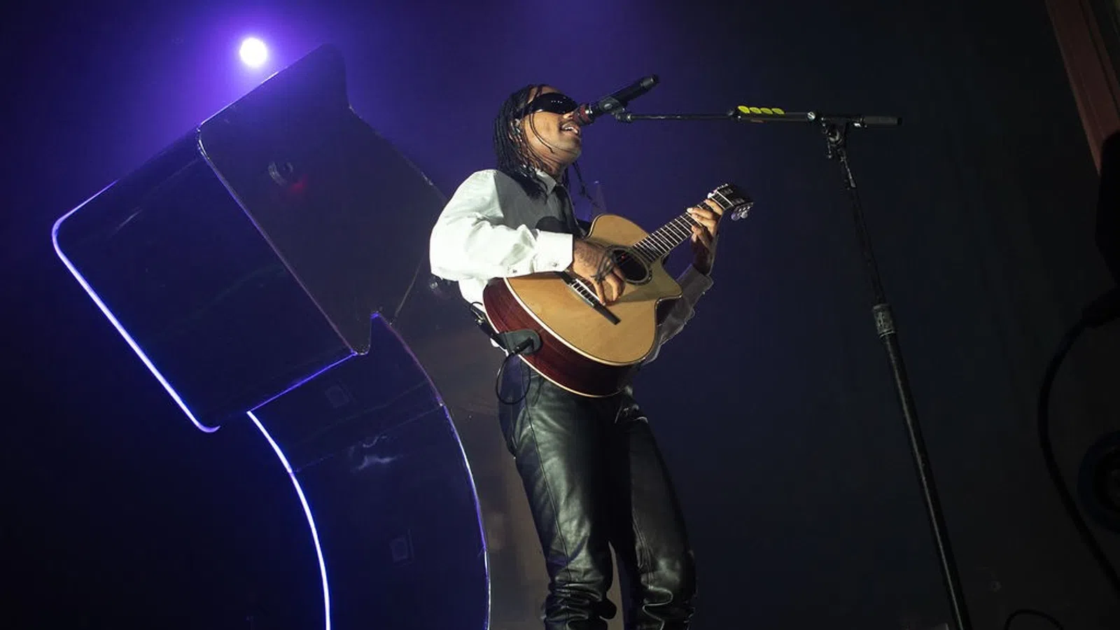 a person playing a guitar on a stage