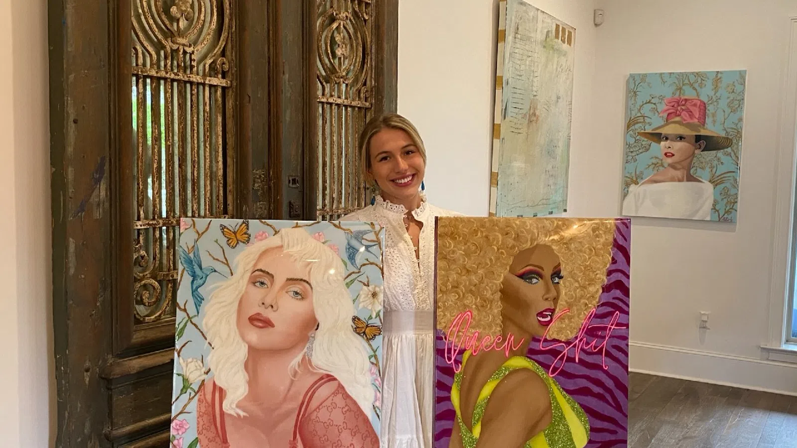 a group of people holding paintings